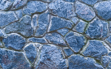 background of a wall of blue stones.
