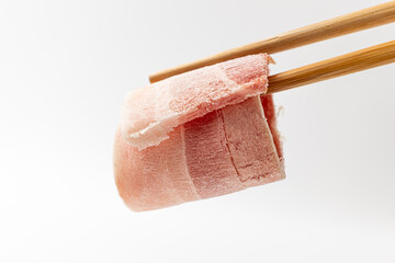 Sliced ​​pork belly on a white background