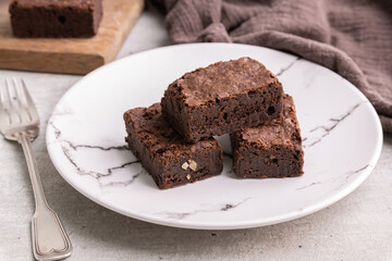 Brownies on a plate over white wooden table