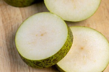 Fresh juicy pear cut into pieces and pieces