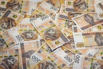 scattered banknotes of PLN 200