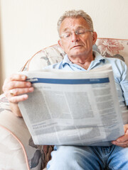 Retirement: Reading the newspaper. A senior man engrossed in his daily news as he keeps informed of...