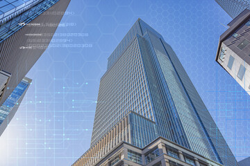 Fototapeta na wymiar Business buildings around Tokyo Station under hexagon grid network.
