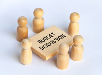 Wooden people figures having business meeting with customizable spare for text or ideas.
