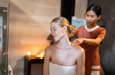 Beautiful young woman sitting on massage beds at luxury massage and spa and wellness center