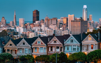 Evening, Painted Ladies Victorian houses in Alamo Square and a view of the San Francisco skyline and skyscrapers. Photo processed in pastel colors