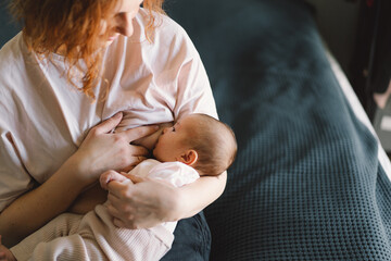 Newborn baby girl sucking milk from mothers breast. Portrait of mom and breastfeeding baby. Concept...