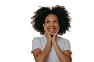 Fototapeta na wymiar Joyful young dark skinned woman feeling happy, smiling at camera and touching cheeks with both hands