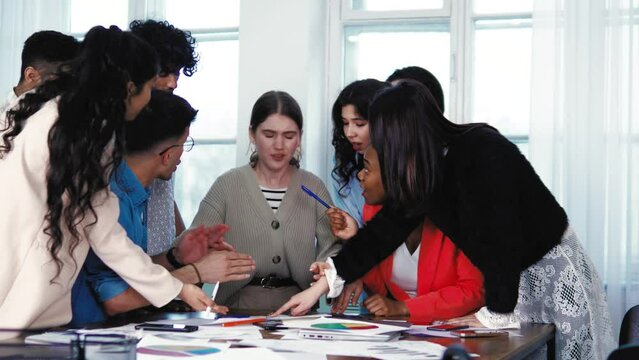 Young caucasian female feeling pressure bullying from her friends students classmates at classroom. Colleagues shouting screaming on innocent young pretty woman. Abuse at college, education system