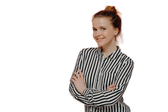 Positive young ginger lady with crossed arms smiling at camera