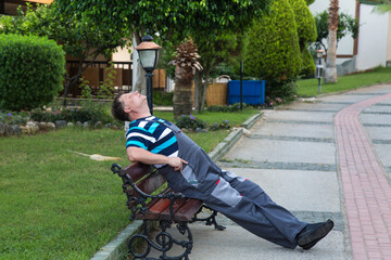 A lazy worker sits on a bench instead of performing his duties.