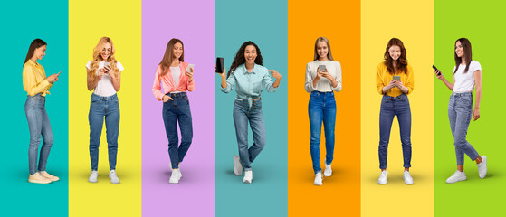 Obraz premium Glad young diverse women in casual typing on smartphone show phone with empty screen