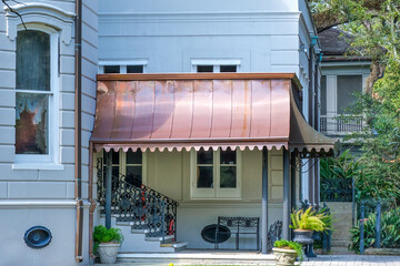 Side Section of Building Displaying a Copper Shade over a Side Entrance