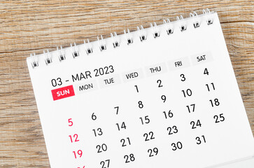 The March 2023 Monthly desk calendar for 2023 year on wooden background.