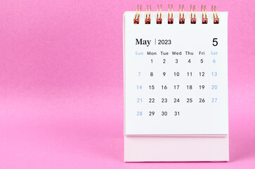 A May 2023 desk calendar on pink color background. - obrazy, fototapety, plakaty