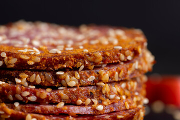 Sliced sausage with spices and lots of sesame seeds