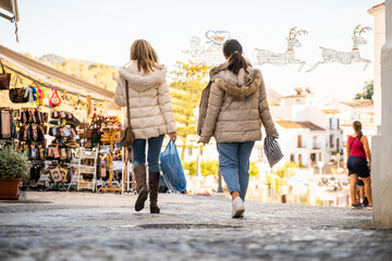 women strolling through a Christmas market