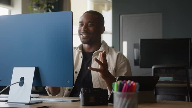 Young Black male in  having videochat preparing a project in a modern office
