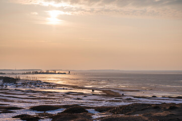 sunset over the beach and frozen sea in winter. Kalajoki, Finland
