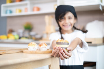 Adorable Asian girls enjoy making baked goods in pastry and bakery class at culinary school.