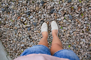 Woman standing on the rock ground. Focus of the woman's leg. For travel concept.
