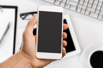 Hand hold modern smartphone with a blank screen