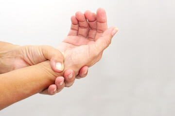 Woman with pain in wrist on white background with clipping path. Healthcare and office syndrome concept.