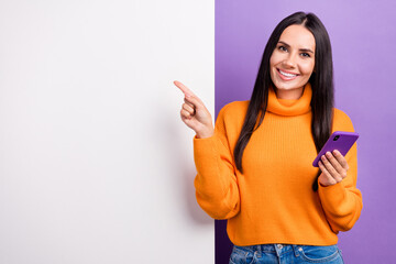 Photo of millennial lady use gadget indicate eshop ads point white billboard isolated purple color...