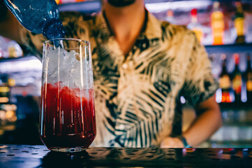 man hand bartender making cocktail in glass on the bar counter