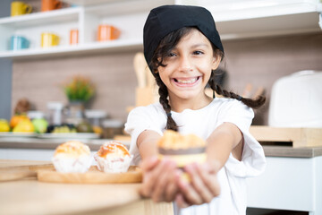 Adorable Asian girls enjoy making baked goods in pastry and bakery class at culinary school.