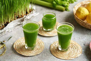 Fresh green barley grass juice with fresh homegrown blades on a table