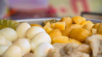 Potatoes, Tofu and Eggs steaming in a steam pot.Street food named Siomay in Indonesia