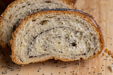 Poppy seeds and a bun with poppy seeds on the table