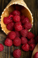 Harvested red ripe raspberries in a waffle cone