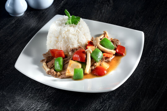 Close up view of white thai rice with stewed beef and vegetables
