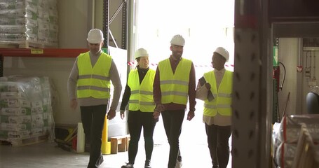 4k slow-motion video of a multiracial group of coworkers cheerfully walking into the warehouse, ready for the new work day.