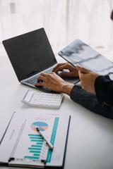 Entrepreneur Asian businessman and businesswoman discussing new business project in tablet in modern Meeting In Modern Office, Asian business casual concept.