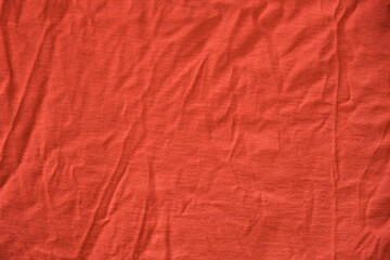 Red crumpled textile material. Texture or background.
