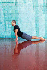 Man practicing yoga over water reflection. Mindfulness concept.