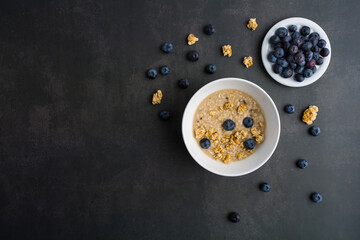 Delicious homemade granola in glass jar, fresh blueberries Healthy food sweet dessert snack. Diet nutrition concept.