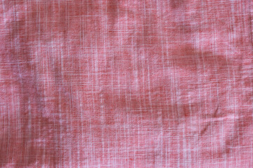 Mint pink linen fabric as a background.