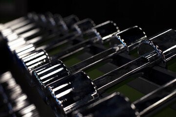 rack with chrome dumbbells