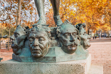 Close up on masks of The Mask Seller statue by Zacharie Astruc in the Luxembourg garden in Paris, France - obrazy, fototapety, plakaty