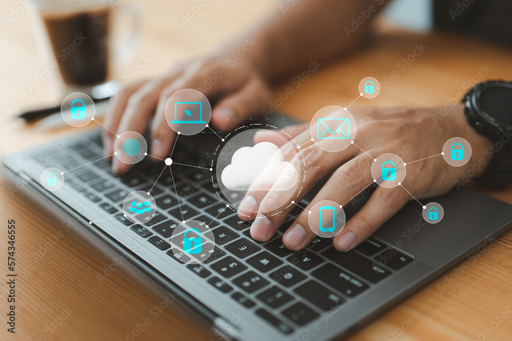 Fototapete businessman using his laptop in an office and selecting the cloud icon on a virtual display. This represents the utilization of digital technology and cloud technology.