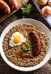 Lentil stew with baked sausageand egg, traditional Slovak food.