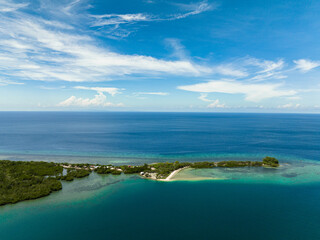 Shore of the island with the beach and blue sea.Turtle Islands, Negros, Philippines