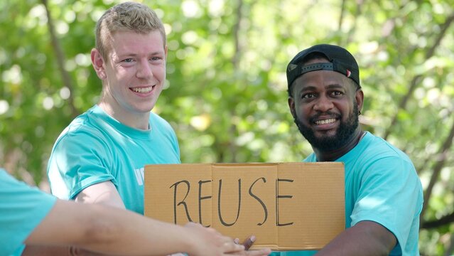 Volunteer To Help Save Nature, Pick Up Trash, Hold A Re-use Sign Activists Starting Work With Cheering And Stacking Hands In The Circle