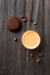 Waste coffee, cup of espresso on a black wooden background top view.
