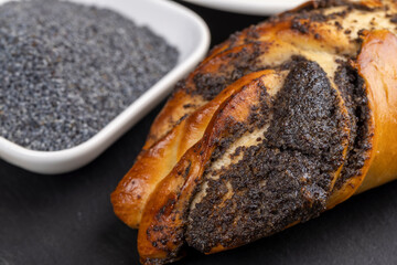 Fresh bun with poppy seed filling on the table