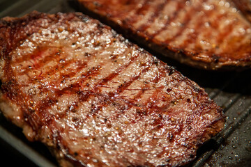 Raw minute steak of marbled beef in a grill pan